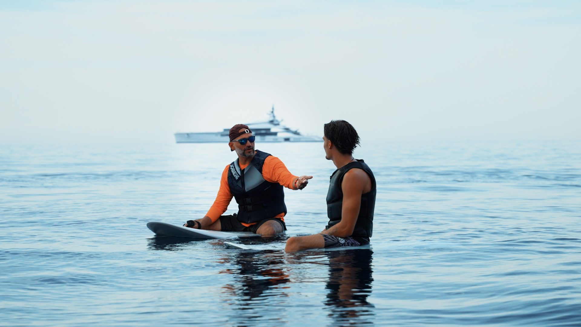 Instructor coaching a guest during an eFoil lesson on calm water